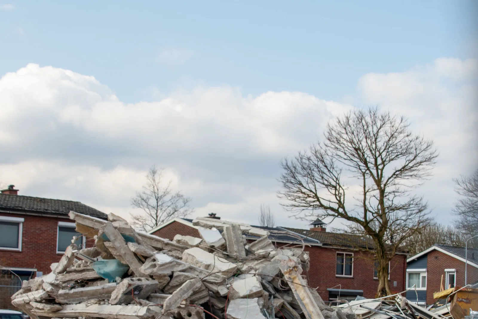 A residential building site covered in offcuts, packaging and builders waste before cleanup.